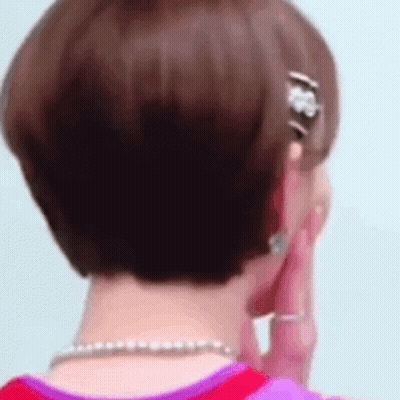 Woman Talking On Phone With Earrings And Necklace GIF