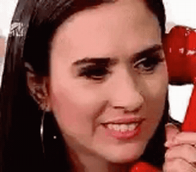Woman Talking On Red Phone Smiling GIF