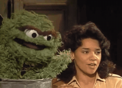 Woman Talking To Green Sesame Street Character GIF