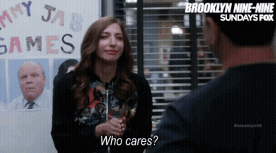 Woman Talking To Man In Front Of Games Sign GIF