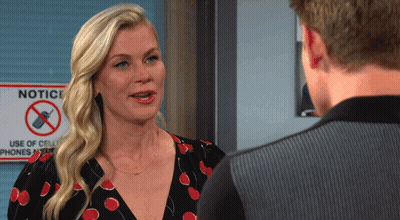 Woman Talking To Man In Front Of Notice Sign GIF