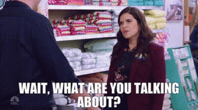 Woman Talking To Man In Store Next To Towel Shelf GIF