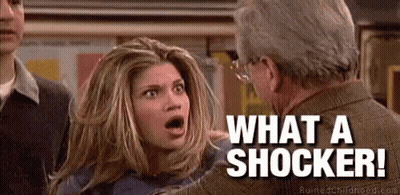 Woman Talking To Shocked Man Saying What A Shocker GIF