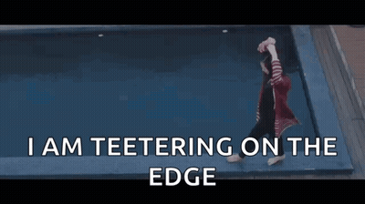 Woman Teetering On Edge Of Pool GIF