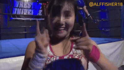 Woman Thumbs Up In Front Of Wrestle University Sign GIF