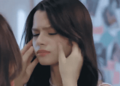 Woman Touching Another Woman's Face In Mirror GIF