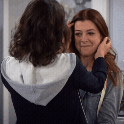 Woman Touching Another Woman's Hair Making Face GIF