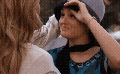 Woman Touching Another Woman's Hat GIF