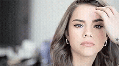 Woman Touching Forehead Looking At Camera GIF