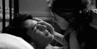 Woman Touching Man's Forehead In Bed GIF