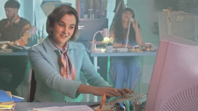 Woman Typing On Pink Computer Monitor GIF