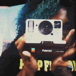 Woman Using A Polaroid Camera