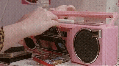 Woman Using Pink Boombox To Play Cassette Tapes GIF