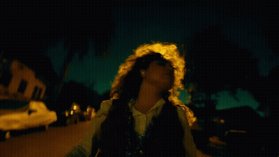 Woman Walking At Night With Yellow Headlight GIF