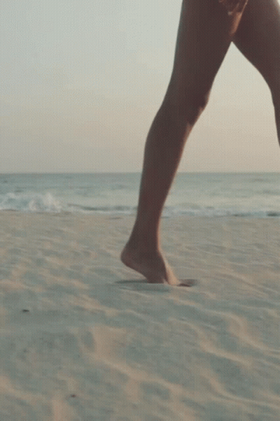 Woman Walking Barefoot On Beach GIF