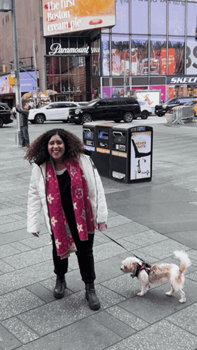 Woman Walking Dog In Front Of Paramount Sign GIF