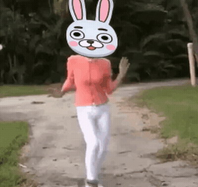 Woman Walking Down Dirt Road With Bunny Head GIF