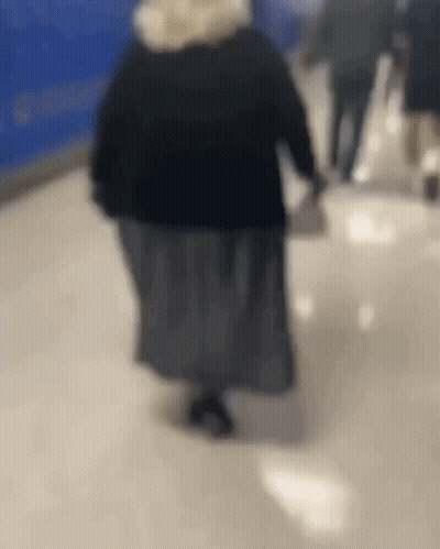 Woman Walking Down Hallway GIF