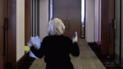 Woman Walking Down Hallway With NPR GIF