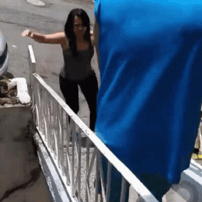 Woman Walking Down Stairs With Blue Blanket GIF