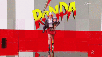 Woman Walking In Front Of Ronda Logo GIF