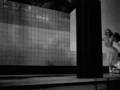 Woman Walking In Front Of Tiled Wall GIF