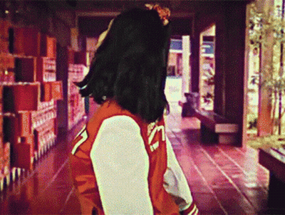 Woman Walking In Red And White Varsity Jacket GIF