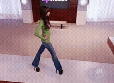 Woman Walking Runway In Front Of Top Model Sign GIF