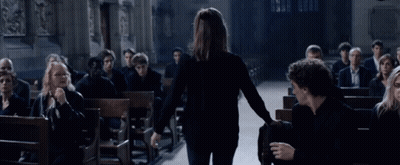 Woman Walking Through Church With People In Pews GIF