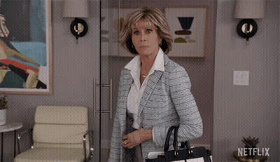 Woman Walking Through Glass Door Netflix Logo GIF