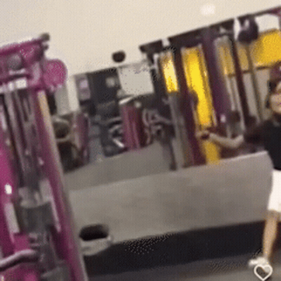 Woman Walking Through Gym With Heart Shoe GIF