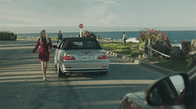 Woman Walking Towards Silver Car With License Plate EW2123 GIF