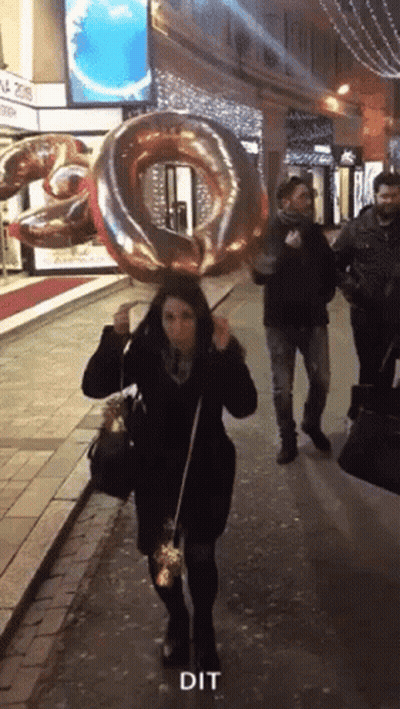 Woman Walking With Balloon Saying Dit GIF