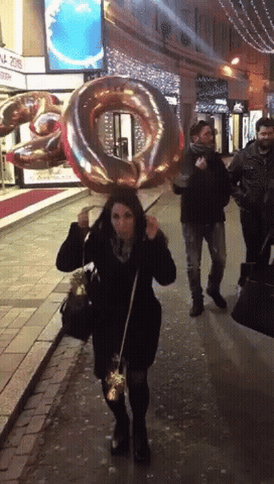 Woman Walking With Number 20 Balloon GIF