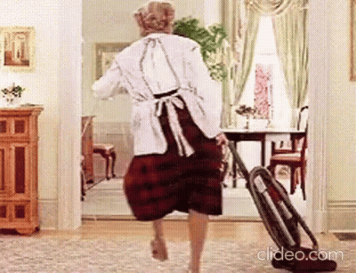 Woman Walking With Vacuum Cleaner In Living Room GIF