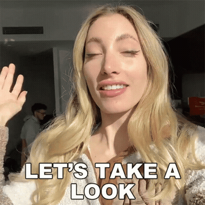 Woman Waving Hand Saying Let's Take A Look GIF