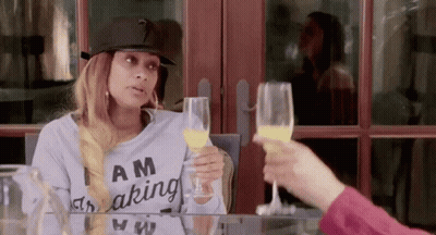 Woman Wearing Am Making Shirt Holding Orange Juice GIF