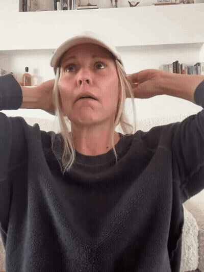 Woman Wearing Baseball Cap And Sweater GIF