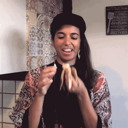 Woman Wearing Black Cap Eating Banana GIF