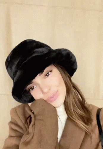 Woman Wearing Black Furry Hat And Brown Coat GIF