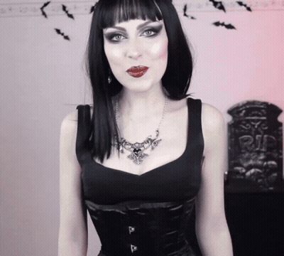 Woman Wearing Black Top And Heart Necklace GIF