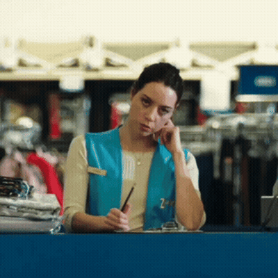 Woman Wearing Blue Vest With Z On Phone GIF