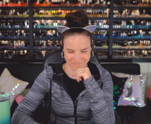 Woman Wearing Cat Ear Headband And Earrings GIF