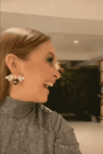 Woman Wearing Earrings And Turtleneck GIF
