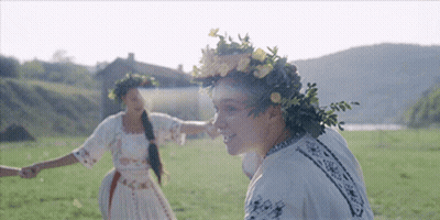 Woman Wearing Flower Wreath Holding Nose GIF