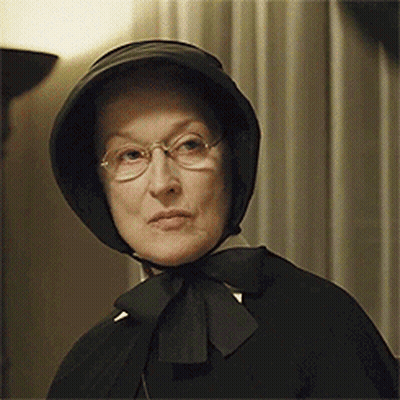 Woman Wearing Glasses And Black Bow Hat GIF