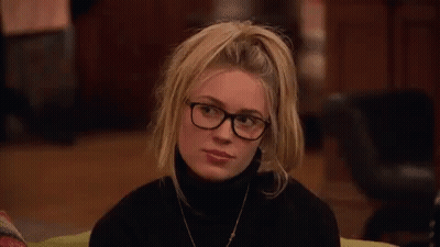 Woman Wearing Glasses And Black Turtleneck Smiling GIF