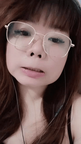 Woman Wearing Glasses And Earbuds GIF