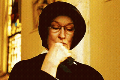 Woman Wearing Glasses And Hat Holding Knife In Mouth GIF