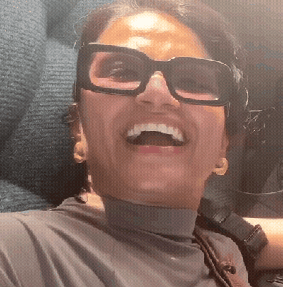 Woman Wearing Glasses And Turtleneck Smiling GIF